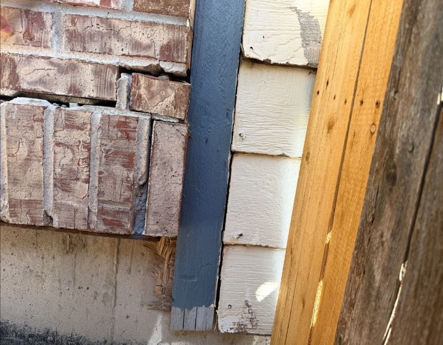 Image of the closeup of damaged siding on a house.