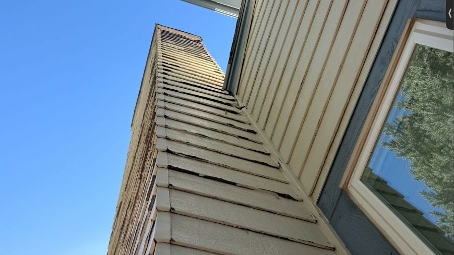 Closeup of a house siding that needs to be updated